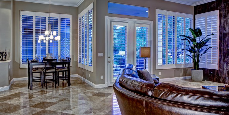 Phoenix great room with plantation shutters and leather furniture.